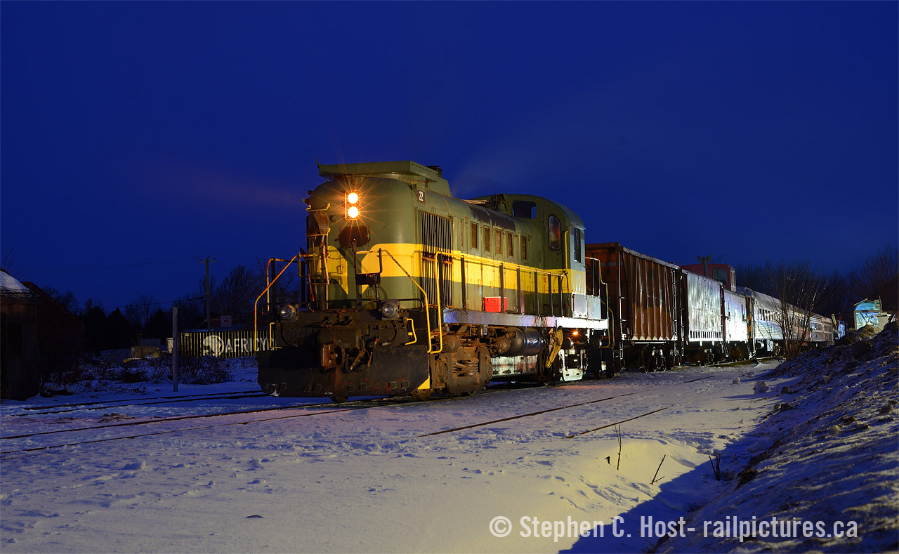 T'was three nights before Christmas, and all through Uxbridge, creatures were scurrying to capture night shots of trains. Pictured is 244-powered GVLX 22 (nee YDHR, nee R&S) The RERA folks are working to prepare the train for a 7 PM departure out of Uxbridge "for the last time", and will soon add a 2'nd locomotive to the head end before departure. Merry Christmas to all railpictures.ca viewers, and here's a story from last Sunday.

The Rail Equipment Restoration Association put on a really great show and effort, not only are they valiantly working on preserving all of the remaining YDHR equipment, including the 3 MLW/Alco's on the property, the crew hatched a plan to bring the Uxbridge rail yard to life for one last time.  The goal was to get all the equipment to the GO Linconville layover yard area where CN will lift and send to their next destinations. The plan? Re-activate the serviceable locomotives, prepare all equipment for movement, and run a train out of town. The problem? Problems. Too many to list here, but let's just say this:  These locomotives haven't operated a train in over 2 years, and the RERA doesn't have a shortline railway certificate so they need a railway to come operate for them. The Ontario Northland provided this service sending a crew down from North Bay. The town wants the railway gone, and badly, and the pressure was on. There's also the 2% ruling grade of the Toronto and Nippising Railway to deal with. This effort costs money, and a dedicated team of over 10 people are working to complete this plan in a show of guts the Canadian rail preservation world badly needs.
In present day 2025, there are only three operating MLW/Alcos in Ontario: one on the GIO Railway (1859 was re-activated in November) and two active on the Waterloo Central. That's it. The RERA folks  nearly doubled that count during the operation of this train as both 22 (nee R&S same number) and 3612 (nee DW&P/CV same number) were used to haul the trains over the grade. Unfortunately, the ruling grade won and only half the equipment made it to the other side. Plan are being hatched to finish the job and I'm hearing a Brandt truck will be called to complete the task.
The plan is bold and if you want more information, or wish to donate check out their website. The equipment will be disbursed to various projects listed on their site along with other destinations, which will be announced soon. I for one am hoping for a Christmas miracle for the RERA folks.Credit: Lighting in part by Jacob Patterson and the Town of Uxbridge's municipal parking lot lights.