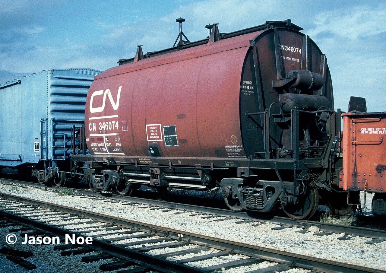 “Return to Temagami Ontario When Empty” stamped on CN "barrel" ore car #346074 is still visible as the iron-ore hopper awaits the scrappers torch at the CN S Yard in Vaughan, Ontario. The car was one of hundreds of freight cars that were scrapped at the yard, which was located at MacMillan Yard near the Highway 7 overpass. Today the yard is long gone, and the site is part of a large transload facility.