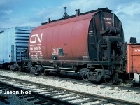 “Return to Temagami Ontario When Empty” stamped on CN "barrel" ore car #346074 is still visible as the iron-ore hopper awaits the scrappers torch at the CN S Yard in Vaughan, Ontario. The car was one of hundreds of freight cars that were scrapped at the yard, which was located at MacMillan Yard near the Highway 7 overpass. Today the yard is long gone, and the site is part of a large transload facility. 