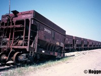 A string of retired veteran CN ore cars is shown awaiting their fate at the S Yard in MacMillan Yard in Vaughan, Ontario. The hopper cars were in the 344000 series, and most were over four decades old, having been built during the mid-1950’s. 