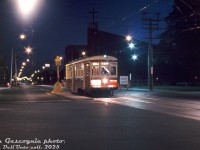 Last Day of Streetcars on Mount Pleasant: TTC Peter Witt 2766, operating on a farewell to the Mount Pleasant streetcar fantrip (1925-1976), poses for photos at the north end of the route facing southbound on Mount Pleasant Road at Eglinton Avenue East in the wee hours of Sunday July 25th 1976, the last day of streetcar service. Visible on the right is the old Eglinton Loop, which will soon see its last car but survive as a bus loop. Further back are the outlines of the St. Peter's Estonian Evangelical Lutheran Church and the Northern Secondary School (see a similar daytime view <a href=http://www.railpictures.ca/?attachment_id=56707><b>here</b></a>).
<br><br>
This was the second last run of the Witt up the line that morning. There was also a regular night car (PCC) running out the final hours in service too. 2766 would head south, loop at St. Clair Subway station, and make one more pass up the line as the sun came up to make it the last streetcar operating on Mount Pleasant.
<br><br>
Diesel buses would briefly handle duties along Mount Pleasant until the new trolleybus service was ready.
<br><br>
<i>Tom Gascoigne photo, Dan Dell'Unto collection slide.</i>
<br><br>
For more info, see transit historian <a href=https://stevemunro.ca/2020/07/25/the-last-night-of-the-mt-pleasant-car/><b>Steve Munro's writeup</b></a> on the last day of operations.