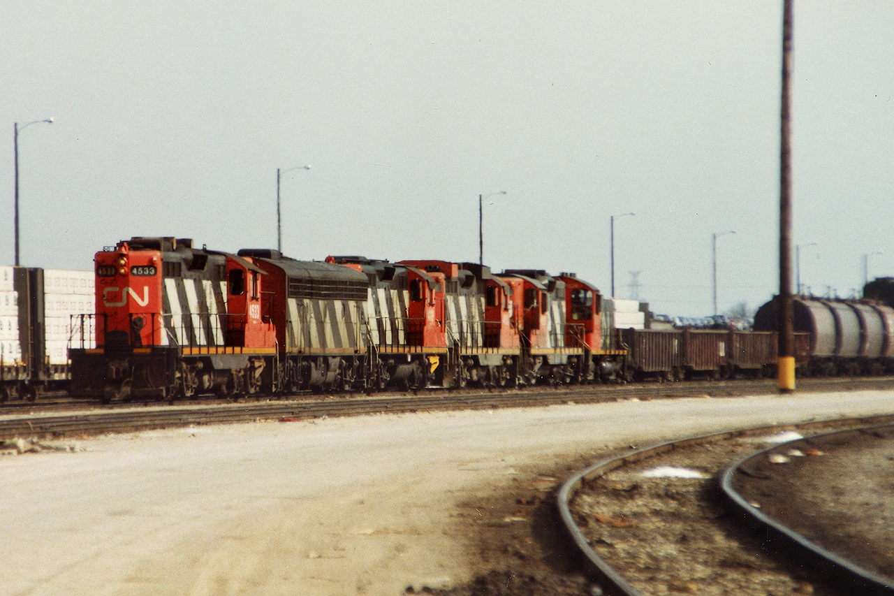 The Fort Erie pool. Everything and anything was possible, although I doubt any railway in North America could have pulled this off at the time. There was usually a second-generation unit leading, and all CN's dregs trailing. But not today....with a Stratford winter assigned GP9 in the consist, and an SW1200 they lifted somewhere, 432 drags what is almost certainly 100+ mostly empties into the Receiving Yard at MacMillan Yard. Those were the days.....
