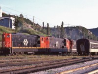<br>
 <br>
…....“ the Narrow Gauge gets into your blood – it will not 'out' ”....
<br>
 <br>
Terra Transport's  daily train #204's power shuffles cars,
<br>
 <br>
and the final move is to attach the CN ( TT - open window) Coach onto the consist to comply with the Transport Commission's order to provide the remote 137 mile route with daily passenger service* from Corner Brook (departing 18:45) to Bishop's Falls (arriving 23:35). 
<br>
 <br>
At Corner Brook, August 2, 1982 Kodachrome by S.Danko
<br>
 <br>
The Power:
<br>
 <br>
four GMD 1956 to 1960 built NF210's: TT#910 ; TT#940 ; TT#917 ; TT#919 (CN noodle) 
<br>
 <br>
plus TT#918 in tow (CN zebra livery) - ground out relay issue 
<br>
 <br>
Note the fresh ballast on the main track (foreground).
<br>
 <br>
Today, I understand that the rail right-of-way is now a vehicle highway.
<br>
 <br>
   *  VIA Rail System Timetable dated November 15, 1981, Table #2. Bishop's Falls – Corner Brook  daily Mixed Trains #203 and #204: reference mark #1 No Checked Baggage. “Mixed Train Services are operated by Terra Transport Ltd.”
<br>
 <br>
More
 <br>
<br>
    <a href="http://www.railpictures.ca/?attachment_id=  54738">  204's power </a>
 <br>
<br>
    <a href="http://www.railpictures.ca/?attachment_id=  46482">  Wreckhouse, Nfld </a>
<br>
 <br>
sdfourty
