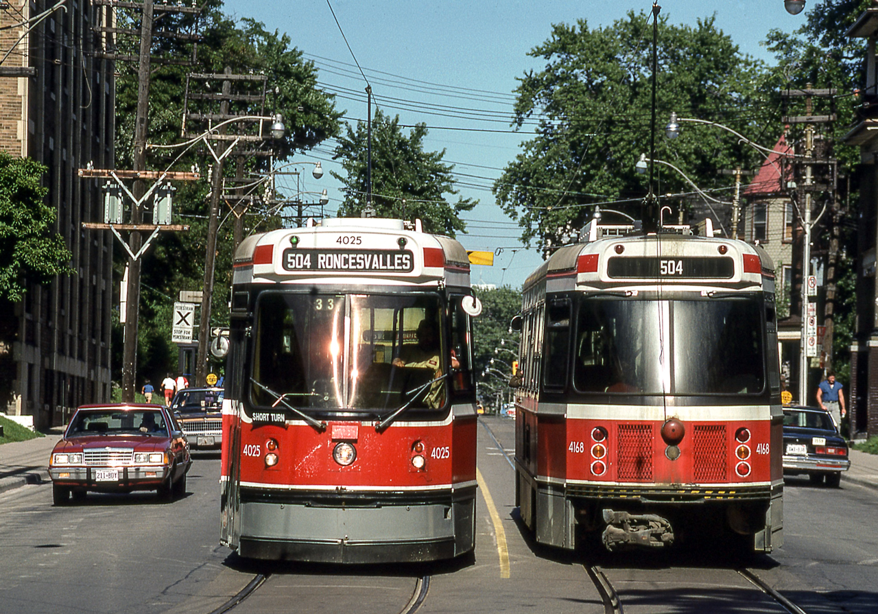 TTC 4025 and TTC 4168 are passing each other in Toronto on August 11, 1987.