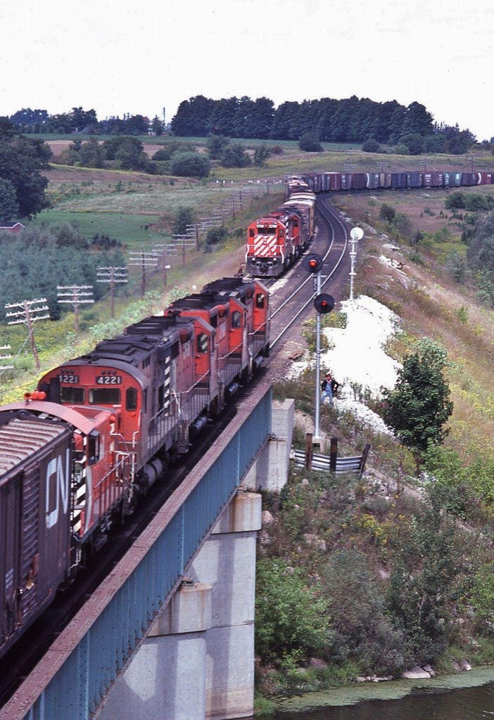 ...eight units....

 
....five models...

 
...three builders...

 
...Geep 35's; C-424; SW1500; SD40-2's and a Geep 30

 
...GMD...MLW...and an EMD....

 
eastbound (on the bridge) CP Rail 5008 – 5019 – 5011 – 4221 with a SW 81xx 

 
& westbound – in the hole, with 'year-lings' CP Rail 5798 – 5799 assisted by  C&O 3004 

 
at the bridge over River Thames, with the westbound crew ready for the inspection, at Coakley,  September 9, 1979 Kodachrome by S.Danko

 
MORE Geep 35's
 

      neat lashup 

 
sdfourty