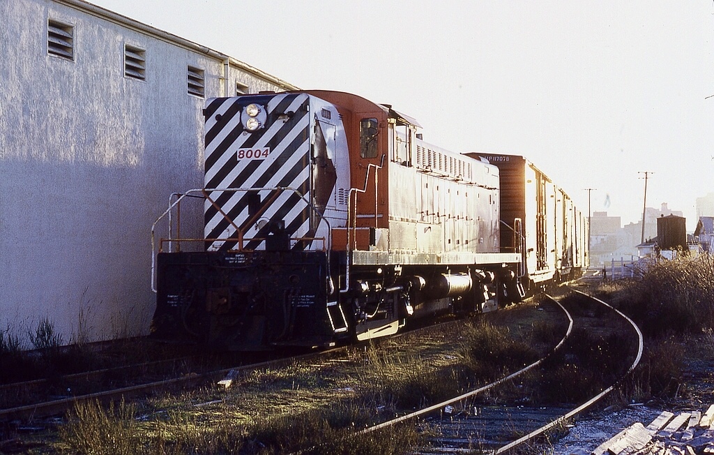 In Victoria, about half a mile short of mile zero on the E&N mainline, CP had a spur from its main yard down to serve harbourfront industries and to connect to Island Tug & Barge’s Lime Bay interchange barge slip to and from U. S. rail connections.  With me on graveyard shift responsible for setting out the unit for the 0600 yard crew, that put me in prime position to know and to catch an unusual assignment of a Baldwin roadswitcher, CP 8004, instead of the usual MLW S-3, switching those industries early in the morning on Saturday 1973-02-03.