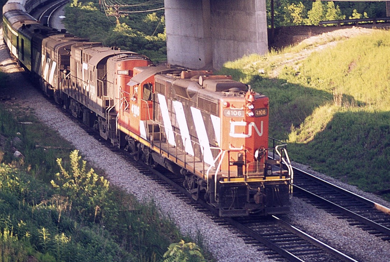 T'was a pleasant evening to be hanging out on the Laking Gardens walk bridge; no doubt there were other fans there. I forget. In this image, late afternoon passenger with CN 4106, 3118 and an unknown B unit is seen rolling westbound under Plains Road West; officially the Wolf Island Bridge.  Not sure of the train number, but by the look of the late day sun this would be #77, and for sure is pre-VIA.