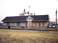 This is an image of the old West Lorne CSX station. It had recently closed and remained in situ until the 1990s. Not sure if it as demolished or moved.
The station was constructed in 1893 for the Lake Ere & Detroit River Railway which eventually evolved into the Pere Marquette Railway before being swallowed by the CSX family.
It is interesting to note that all these little towns in SW Ontario along the line were important. West Lorne is an example of a community that was almost completely reliant on the railway for its commerce. Besides handling passengers and mixed freight, there was also yard tracks, a water tower and stockyards and a freight shed at this location. One could certainly see the importance of the railway since the automobile not even been  developed when this station opened for business.  (looks like an outhouse on the far left!!)
The station had name signs on each end but I elected to post this broadside view because the old water tower in behind identifies the location.
