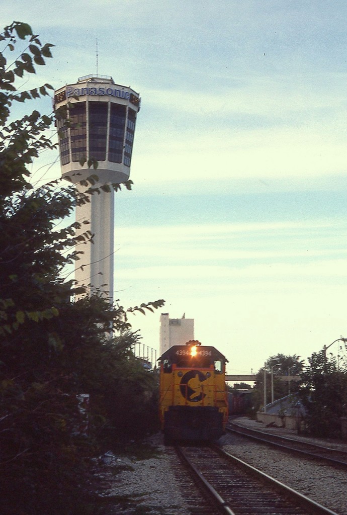 It always frustrated me when the thrice-weekly C&O would show in Niagara Falls so late in the day. Already the train is in dark shadow running thru most of the Falls area, and I wasn't quite able to freeze this shot. With the old film camera this might have been taken at 60th sec and 2.8. But at least I got it. The power for this westbound C&O is 4394 and 4404. Tracks, of course, are long gone (2001) and the Tower is now is lost in a conglomeration of new high rise hotels and the like.