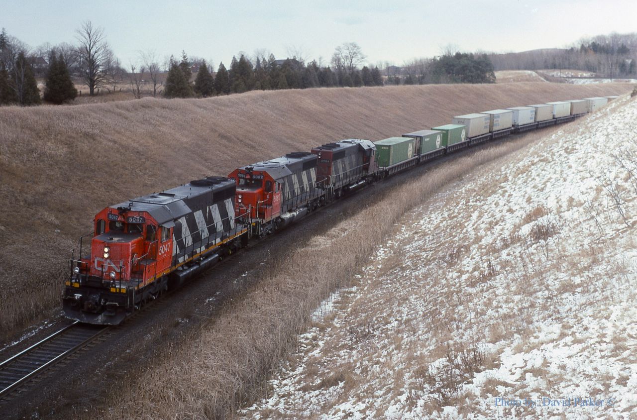 A trio of CN SD40's 5042-5082-5084 has just passed the West switch Beare and passed under the CP Belleville Sub with a Westbound Montreal-Toronto 'Laser' intermodal train. Not a dynamic brake in sight.
Feb 11th 1989