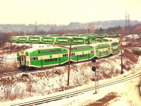 Third time around. I realize I posted a shot of this train in 2012 and 2017, but, after going thru old photos and finding another shot of interest; not quite the same as the one from 11 years ago; but close, I thought this scene was worthy of another look.
I was caught totally by surprise. I'm on the hillside at Hamilton West waiting for whatever CN had to offer. Down the CP line comes a GO train !!! And it kept coming !! To say the least, I was flabbergasted. Apparently, the story was that perhaps a minor incident of sorts on CP around Streetsville temporarily shut down the GALT sub. GO, which was based at Guelph Jct back then, elected to detour its trains over CN Oakville to be ready for the afternoon runs out of Toronto. I am under the assumption buses were eventually supplied for people going in to work that morning and the trains would be ready to take them back home. There are only 4 trainsets in this image, and I understood there were 5 sets based Guelph Jct.   Hmmmm ??
Needless to say, this will never be repeated, which makes it worthy to post for those who were not on RP all those years back.