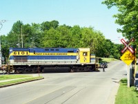 ALCO C-425 #6101, lettered for the fledgling Port Colborne Harbour Railway, is seen heading back to WH Yard after working Goderich Elevator down on the harbour.  This is the first road intersection on the return; crossing Sugarloaf at Elm St on a nice sunny and very warm afternoon. The old locomotive was returned to the New York and Lake Erie railroad in 2001 and is now on the roster of the Delaware-Lackawanna in Pennsylvania.
The PCHR at this time was in its' infancy. The official Grand Opening ceremonies were still a week away.
