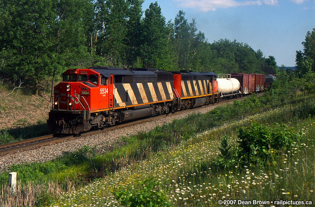 CN SD60F 5534 and CN Dash 8-40CM 2424 seen at Mile 30 on the CN Halton Sub.