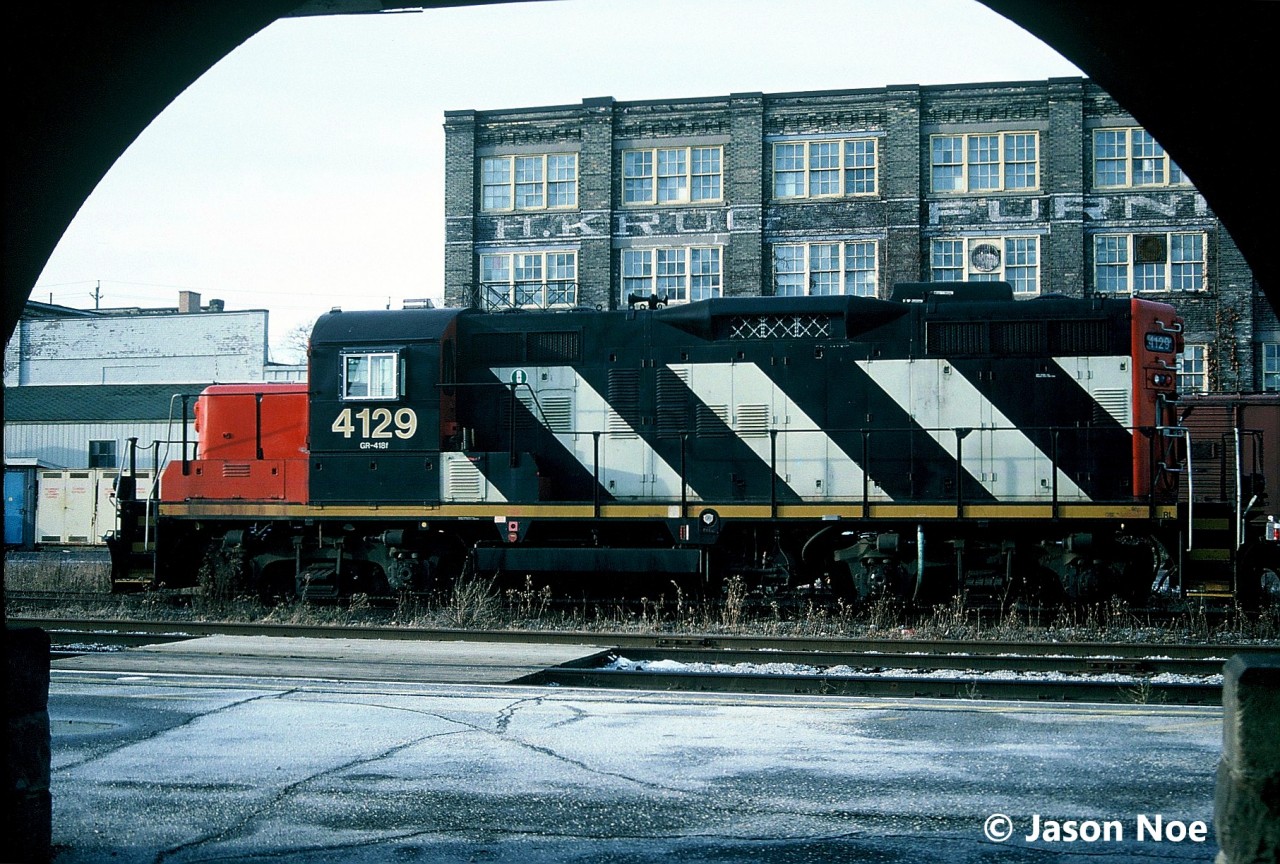 CN GP9RM 4129 is pictured waiting between assignments during a mid-week afternoon in front of the Kitchener, Ontario station. More than 30 years later, 4129 is still active today working on jobs in the eastern Ontario and Quebec area.