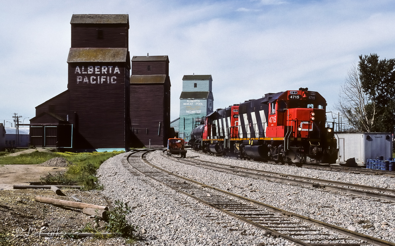 My reason for this picture was inspired by Ian Malenfant-Picard's recent posting of CN 4715 (05/11/2025, search photo 58127). With over 36.5 years between the 2 photos, although the 4715 still looks very much the same, there are a number of small differences. If you look back through my postings, I have taken a number of pictures at this location. But, none look like this. The track has been groomed to perfection. Trains were rolling by so very smoothly, even on the elevator track. As I have mentioned in my other captions, as great as this looked, by November of the same year, the grain elevators were torn down. By early 90's, no more speeders parked in the siding. Replaced by hi-rail trucks. GP38's by this time became the dominant power. In just 5 years (87/92), the face of railroading on this branchline went through quite a change.