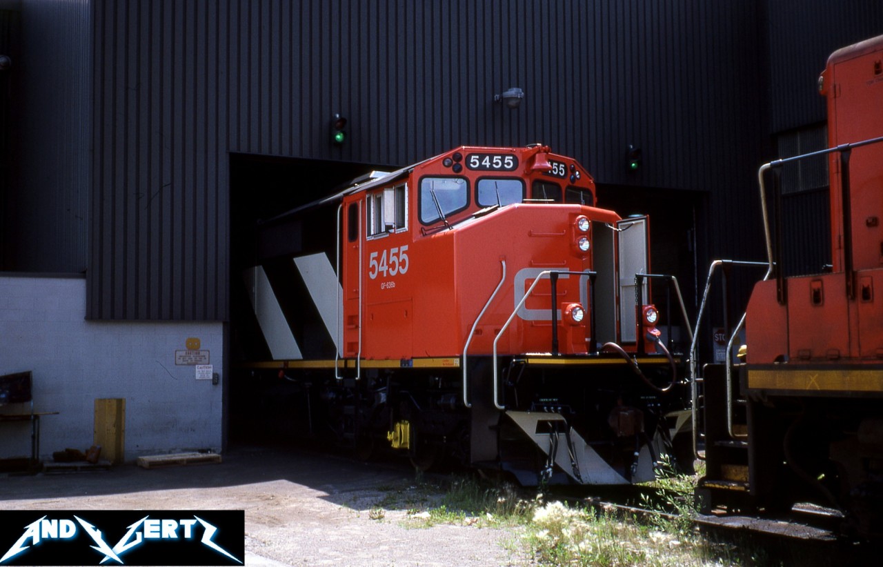 During an early summer day, still new CN SD50F 5455 is captured receiving some attention inside the MacMillan Yard diesel shop in Vaughan, Ontario. The unit was built by GMDD in London during March 1987. It was eventually retired on October 4, 2008 when CN was actively purging it’s SD50F fleet.