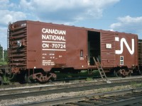 <b> Another rebuild for OCS </b> <br>
Further to the Generator Clothes Drying Car pic I posted a few days ago (<b> http://www.railpictures.ca/?attachment_id=58278 </b>), here is another 40' revenue boxcar converted to OCS duties. <br>
CN 70724 is a Great Lakes Region Engineering Department Fuel & Tool Supply Car pictured here in the consist of GLR Tie Gang #4 at Oba, ON in July 1976. <br>
This car was rebuilt along with many others in a project at Pointe St. Charles shops in Montreal during October 1975 (H.Q. 10 .75) <br>
Some interesting features on this car are: <br>
-high brake wheel and foot stand <br>
-no roof running boards <br>
-ladder rails left in place, but higher rungs removed (at far end of car) <br>
-lower foot stand added to aid in refueling the 1000-gallon reservoir inside the car <br>
-coupler painted in error (AAR Rule 18) <br>
-consolidated stencil under CN logo at far end <br>
-ACI (Automatic Car Identification)/Kar Trak label (left of door opening)