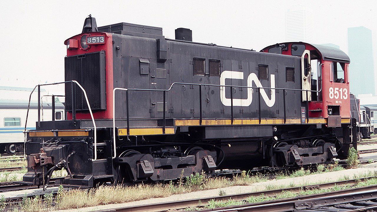 CN 8513 seen at the Toronto Union Station coach yards in August of 1983. These MLW S-13's did the daily chores of bringing Via consists down to the trainshed. The Toronto skyline is seen in the background haze.