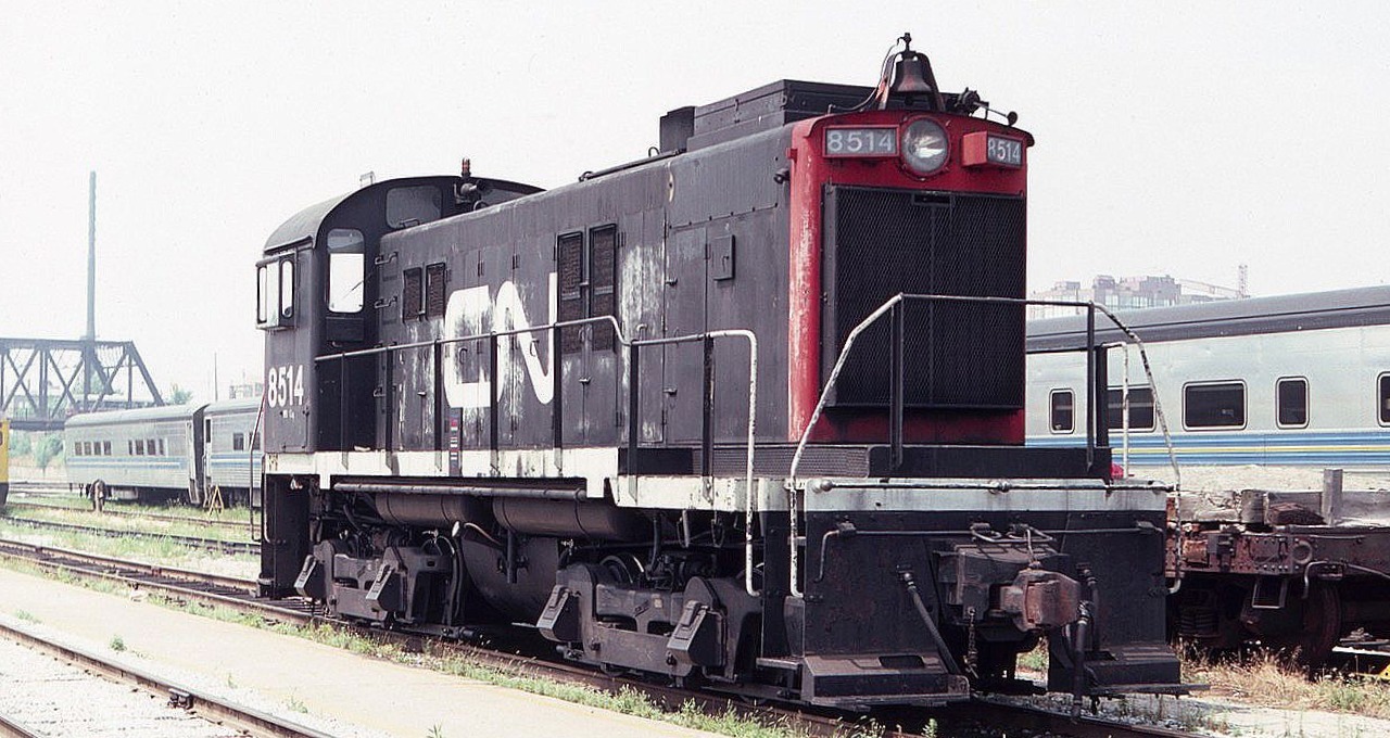 CN 8514 seen at the Toronto Union Station coach yards in August of 1983. Interesting bell, friction journal bearings and footboards on the MLW S-13.