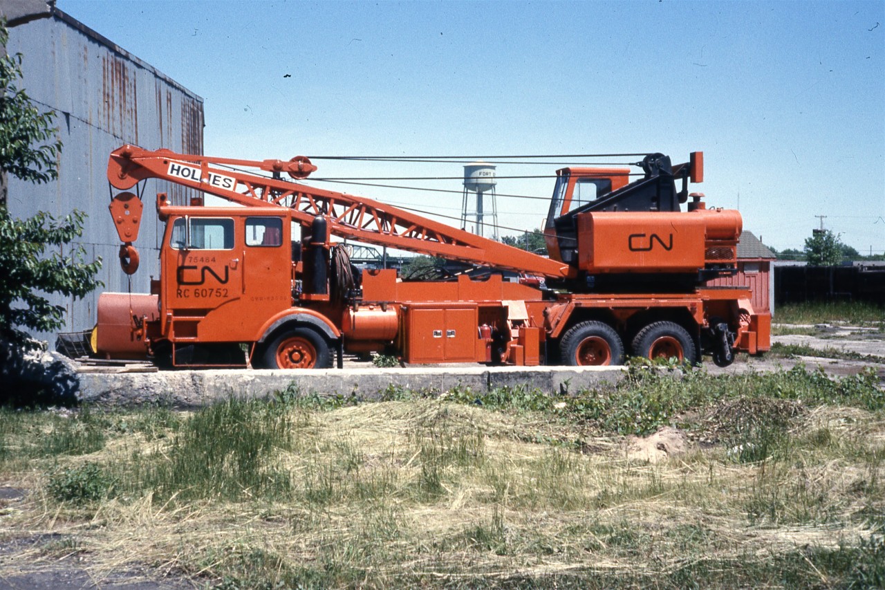 Just a baby  
Not even a year old. Still looking fresh and clean. 
CN RC 60752 (Automotive Services CN E075484) is a Holmes 60-ton capacity hi-rail wrecking crane, serial number xxxx, built in 1975. 
It is seen here at the Fort Erie, ON roundhouse in June 1976.
CN E075484 
E Equipment Dept. 
0 Owned 
7 Truck 
5 1975 
484 sequential vehicle number acquired in 1975