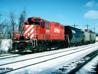 The typical weekday for the CP Guelph local’s crew was to switch the small yard and the nearby lumber yard at Guelph Jct. during the morning. This occurred after all the weekly morning GO Transit sets departed eastbound for Toronto. After its work at Guelph Jct. was completed the job would depart westbound on the Galt Subdivision to Puslinch to service the transload that was situated beside the siding and mainline. At the time, this track (G90), was quite active with several different companies depending on it for rail service. They included; GE Phillips Forwarding, Central Ontario Transfer, Orica Canada and the Upper Canada Stone Company. Following its work here, the crew would return to Guelph Jct. where they would complete any additional switching prior to departing for Guelph if required with usually a small train.
<br>
Here during a frigid sunny winter day, CP GP7u 1501 is pictured working the transload track which was quite full at the time. 

