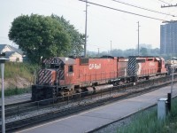 CP M636 4716 and SD40 5517 are making good time as they head eastward through Long Branch, Ontario on CN's Oakville Sub on a very muggy and smoggy June afternoon.