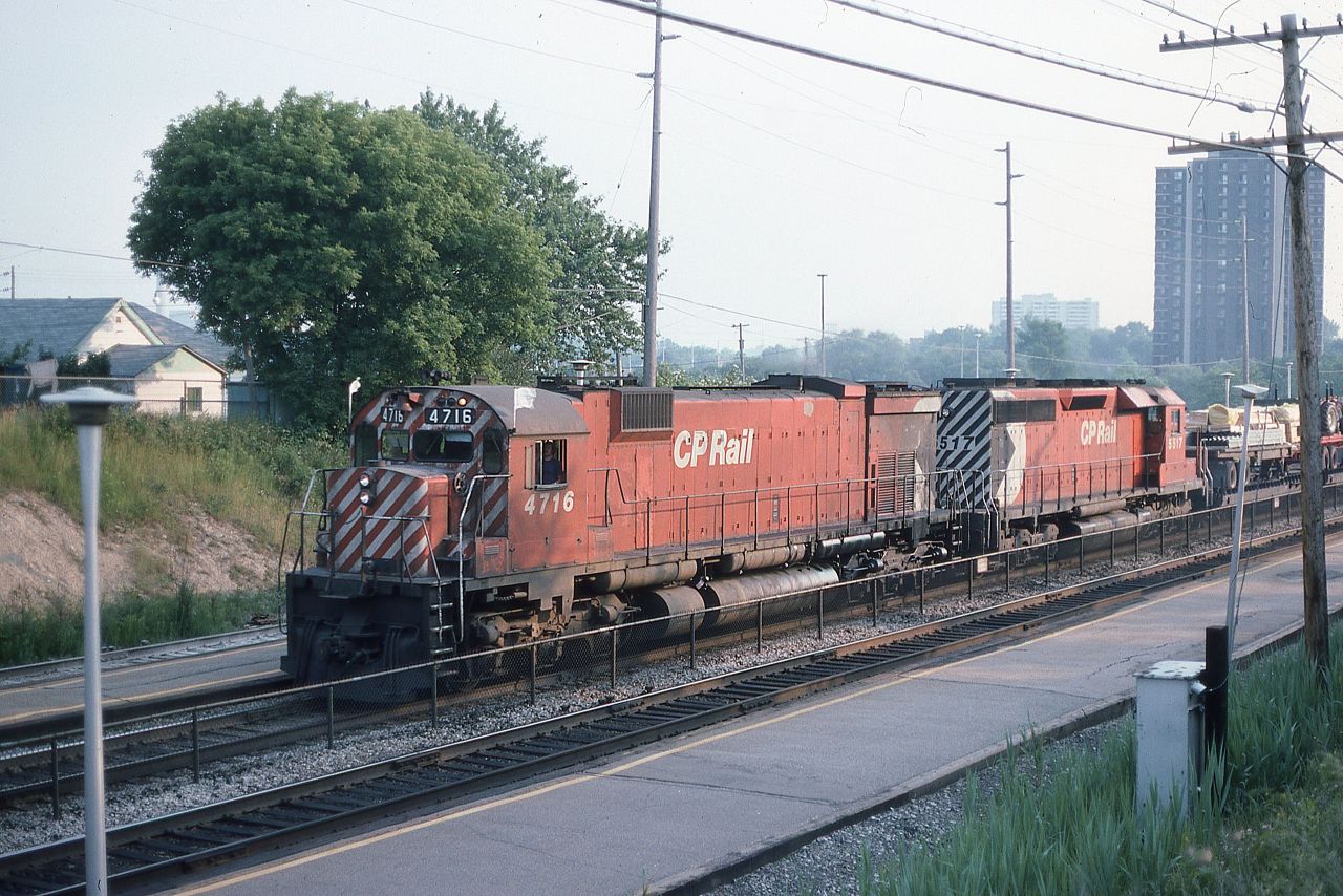 CP M636 4716 and SD40 5517 are making good time as they head eastward through Long Branch, Ontario on CN's Oakville Sub on a very muggy and smoggy June afternoon.