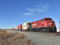  CP 7470 wearing the Lord Strathcona Horse Regiment coat-of-arms, leads a lengthy Eastbound double-stack (Possibly CP#100) at newly named station 'Golden Hills' with not a single hill in sight. This is just West of Carseland, Alberta.  
