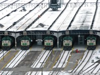 Almost like they're huddled together for warmth, GO Transit F59PH units 548, 539, 523, 538 and 542 sit tucked under the east end of the train shed at Toronto Union Station on a cold January afternoon, in charge of the rush-hour trains from Toronto awaiting departure.<br><br>The time is 3:44pm. Each F59 heads up a different train, that always used the same regular track/platforms for loading every day:<br>-542 on Track 3 is on Lakeshore West train #479 for Burlington, departing west at 4:10pm<br>-538 on Track 4 is on Lakeshore East train #430 for Oshawa, departing at 4:10pm<br>-523 on Track 5 is on Lakeshore East train #410 for Pickering, departing first at 3:45pm<br>-539 on Track 6 is on Bradford Line train #801 for Bradford, departing at 4:10pm<br>-548 on Track 7 is on Milton Line train #151 for Milton, departing later at 4:30pm<br><br>Once one F59 disappeared, another would soon take its place, poking its angular head out from under the train shed until its own departure time arrived. And the never-ending parade of F59's and bilevels continued well into the evening, getting all the downtown office workers home on time, most of the time (for that was the way of the F59 for many, many years...)