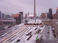 Early morning weekday at Toronto Union Station. It's 7:43am and a dull pink hue from the budding sunrise casts itself over a cold winter scene downtown. Switch heaters hum quietly and the odd clicking of switch points being lined by the nearby Scott Street tower TMD can be heard against the general faint downtown noise.<br><br>Three GO Transit F59PH's can be seen under the drafty train shed: 535 on Track 4 about to depart with eastbound #406 to Pickering, an unknown unit on Track 3 (likely on #477 departing for Burlington soon), and another unknown unit on Track 1 (possibly #832 recently arrived from Richmond Hill). Soon the endless clickity clack of additional F59's and bilevels passing their way through multiple slip switches on the ladder tracks right outside the window would follow, as more morning trains arrived from the east and deadheading equipment moves departed for their next runs.<br><br>Down at Union Station it's just starting to get busy, with sleepy commuters flooding the GO concourse off recently arrived Oshawa, Hamilton, Richmond Hill, Oakville and Milton inbound trains, some ordering breakfast at the McDonalds, grabbing a coffee from the Second Cup, a paper from one of the Gateway Newstand kiosks, or maybe a tasty snack from Mmmuffins or The Bagel Shop before hitting the PATH network or subway to work or school (it's a bit too early to hit up the Cinnabon or LCBO, unless you're a certain kind of person).<br><br>Outside it's mostly quiet at the nearby Union Station bus terminal as stray GO buses lay over, including a 1600-series Prevost and some MCI D4500's (and it would remain mostly quiet until the rush hour trains stopped running and afternoon bus runs picked up). A TTC 6200-series GM/MCI "Classic" on the 6 Bay route waits at the bus stop on Bay Street outside the GO concourse entrance. Residents in the "few" (compared to today) surrounding condos are starting to get ready for work, and patrons staying at the Royal York Hotel are hitting their alarm clocks before dressing for important meetings downtown. Part of the John St. Roundhouse and coaling tower are barely visible and sit deserted, as the whole rail museum thing hasn't happened yet. Work continues on the Yonge Street viaduct rehabilitation project below, and traffic on Bay and Yonge is sparse with the Gardiner moving well for now. Skydome/Rogers Centre report: the dome is definitely closed today.<br><br>The Canadian: on-time with VIA 6404 & 6432 leading. Amtrak Maple Leaf: on-time departure with P32AC-DM 702(!). CN local for switching the Toronto Portlands: eastbound with GP9RM's 7080 & 4100. Union Pearson Express: didn't exist yet. Number of MP40's seen: didn't exist yet. Northlander: still existed, but missed it (drat).<br><br>Apparently it was to be very snowy in the afternoon and there was a very important computer science exam at the Ramsay Wright Zoological Laboratories to attend around the same time, thus the early trip into the city allowing plenty of review time (and avoiding any potential GO bus or train delays).