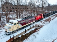 The first train since Christmas arrives in Tillsonburg with an odd looking pair of bedfellows leading the charge. Not known for frequenting the TBurg- OSR 1401, battered in snow bares evidence of battling the snow drifts left behind from the storm the week prior. Seen arriving into town from the new look CASO bridge this shot has opened up dramatically from years past. Too bad the old tell-tail didn't survive the make-over.