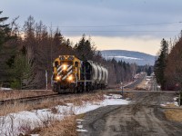 A pair of SFG RS18us pulls a short cement train in the former town of Saint-Omer, now part of the Carleton-Sur-Mer municipality. The lenght of the train was rather disapointing, but atleast the picture didn't come out too bad, it would have certainly been nice to hear these engines roar over that hill like they do when they have a longer train!