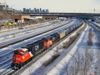 Empty ethanol train CN 713 passes the skyline of downtown Montreal on yet another freezing morning with fresh CN 8352 leading (CN 2873 trails).