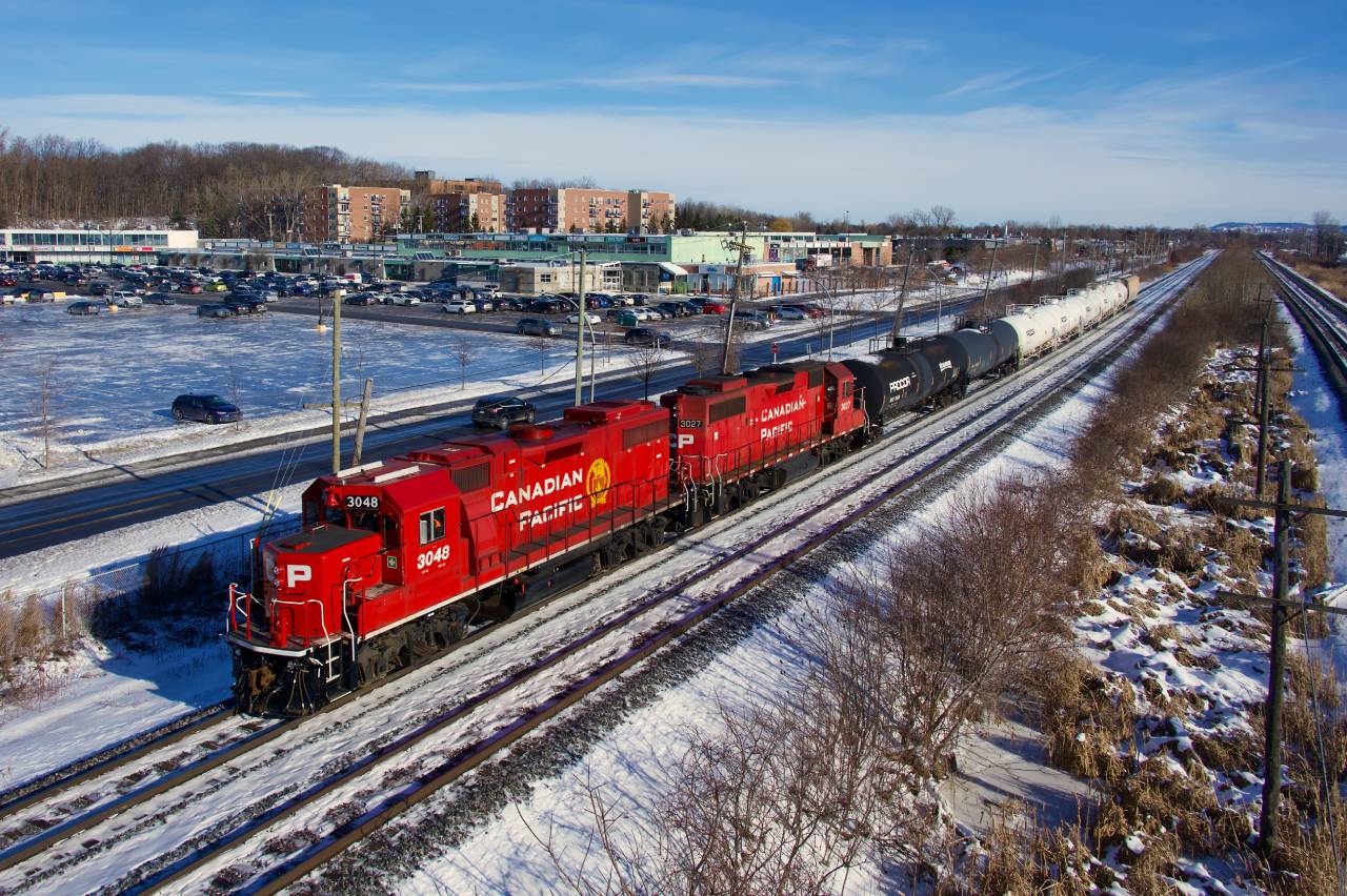 GP38-2s CP 3048 & CP 3027 head west with local CPKC G95.