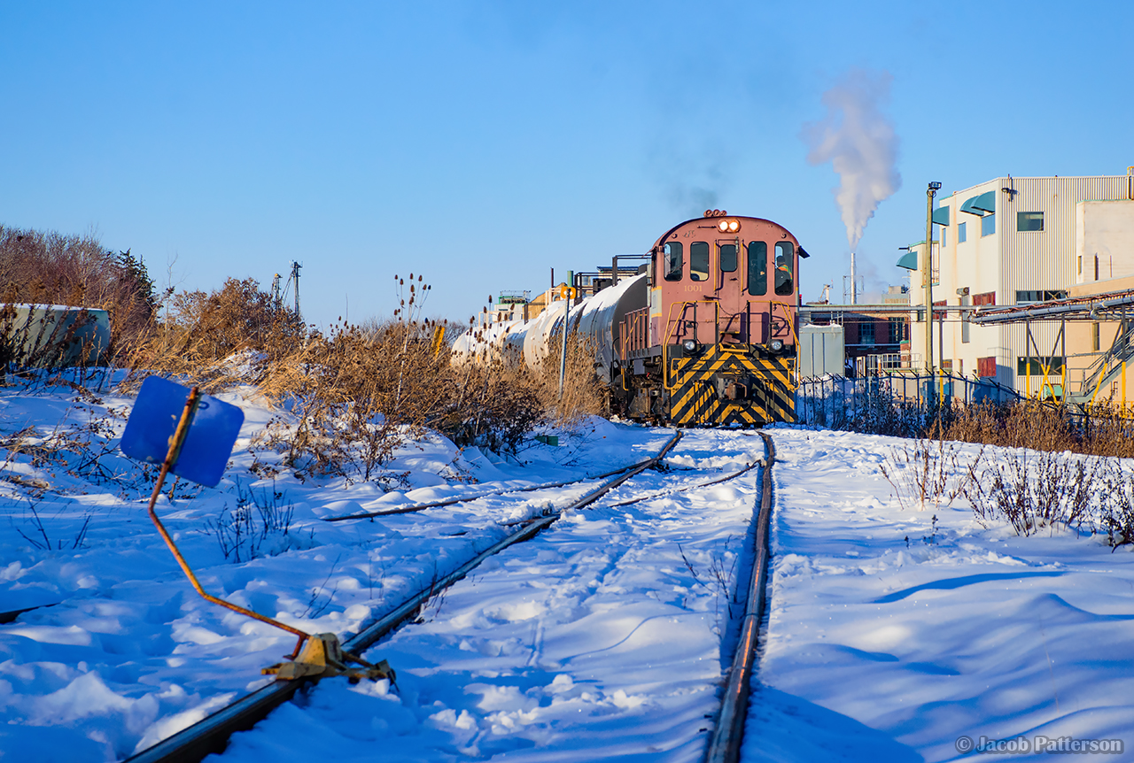 Under a clear winter sky, the throaty chug of Waterloo Central S13 1001 fills the air as J.S. and J.B. switch out cars from CN for Lanxess.