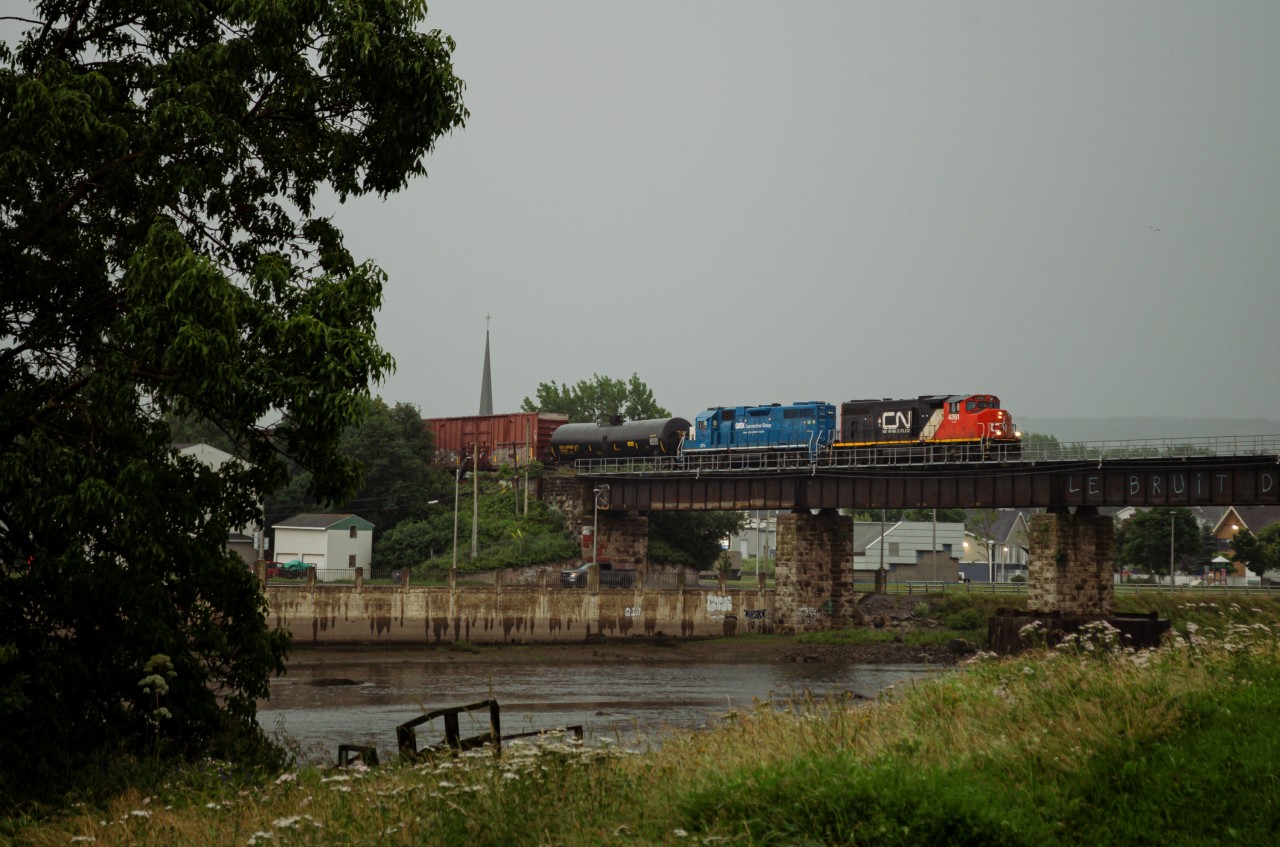 CN 559 crossing the Rimouski river in a rainy early evening. The rain broke away just in time for the train to pass, with a few rays of sun peaking through the clouds. This wouldn't last long though, as rain would pick back up a mere 15 minutes later.