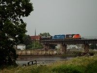 CN 559 crossing the Rimouski river in a rainy early evening. The rain broke away just in time for the train to pass, with a few rays of sun peaking through the clouds. This wouldn't last long though, as rain would pick back up a mere 15 minutes later.