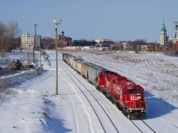 CPKC XRS-04 passes the empty Hochelaga Yard with nine grain cars for the Port of Montreal. Power is CP 3057 & CP 2279.