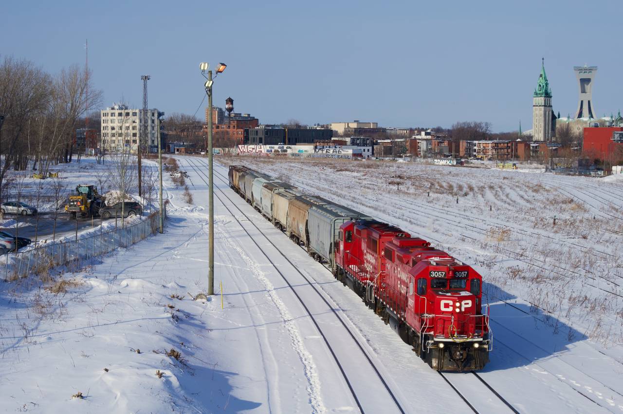 CPKC XRS-04 passes the empty Hochelaga Yard with nine grain cars for the Port of Montreal. Power is CP 3057 & CP 2279.