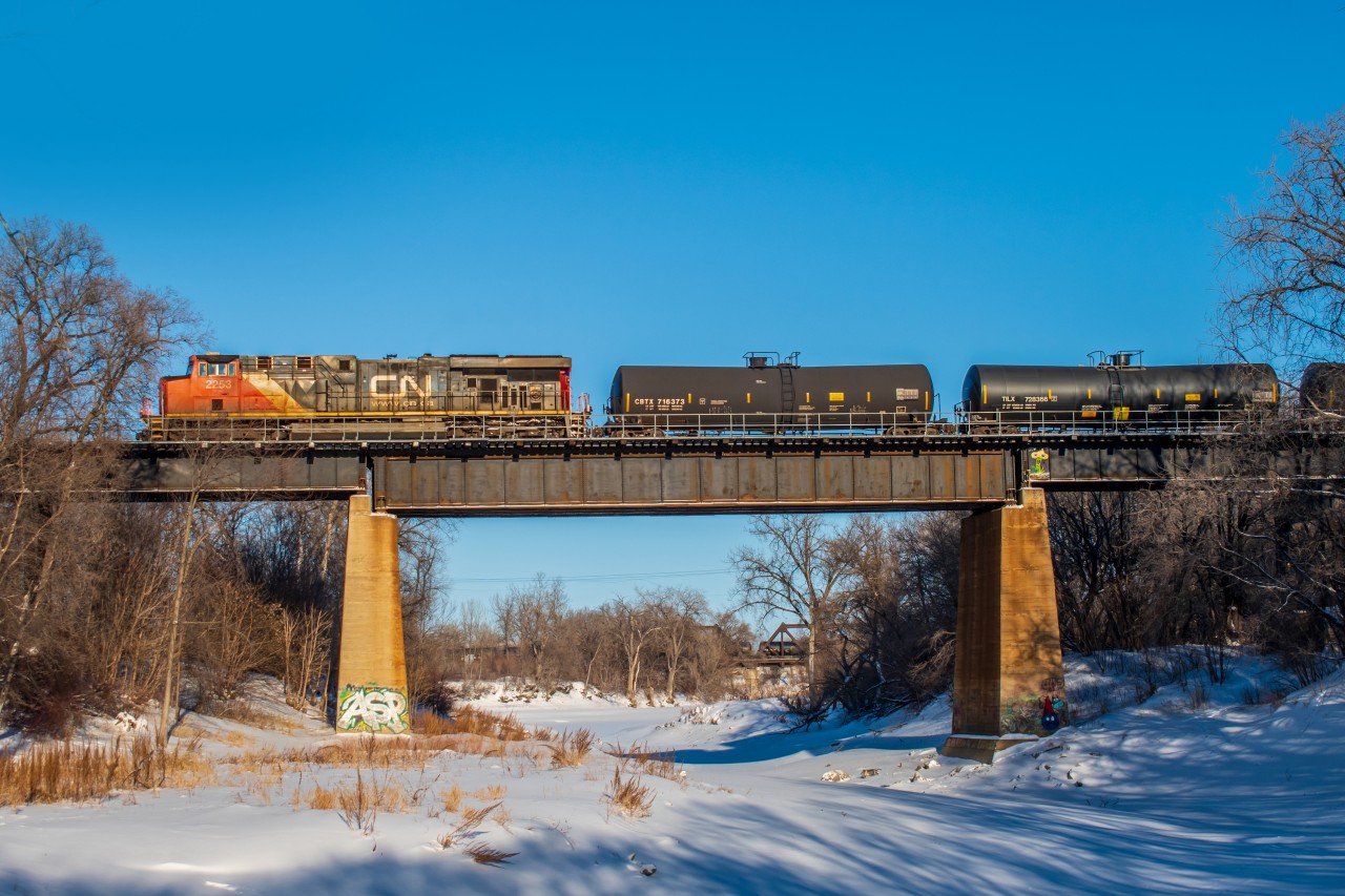 CN 2253 leading their mixed freight train over the frozen Seine River. While in the early stages of leaving Winnipeg on their Western journey.