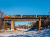 CN 2253 leading their mixed freight train over the frozen Seine River. While in the early stages of leaving Winnipeg on their Western journey.