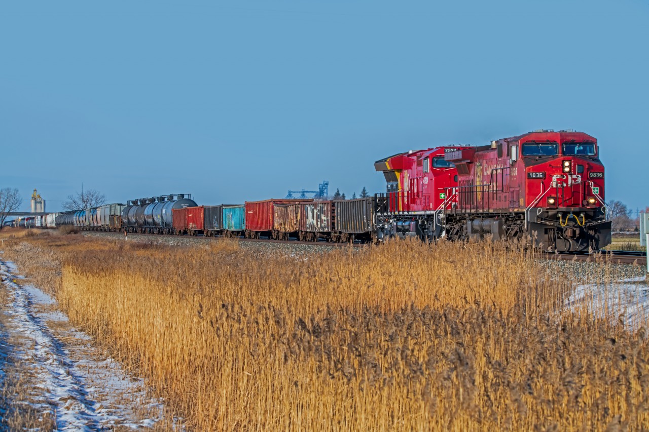 A dirty CP 9836 with it's arts and crafts number board entering the East edge of Winnipeg.