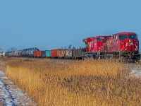 A dirty CP 9836 with it's arts and crafts number board entering the East edge of Winnipeg.