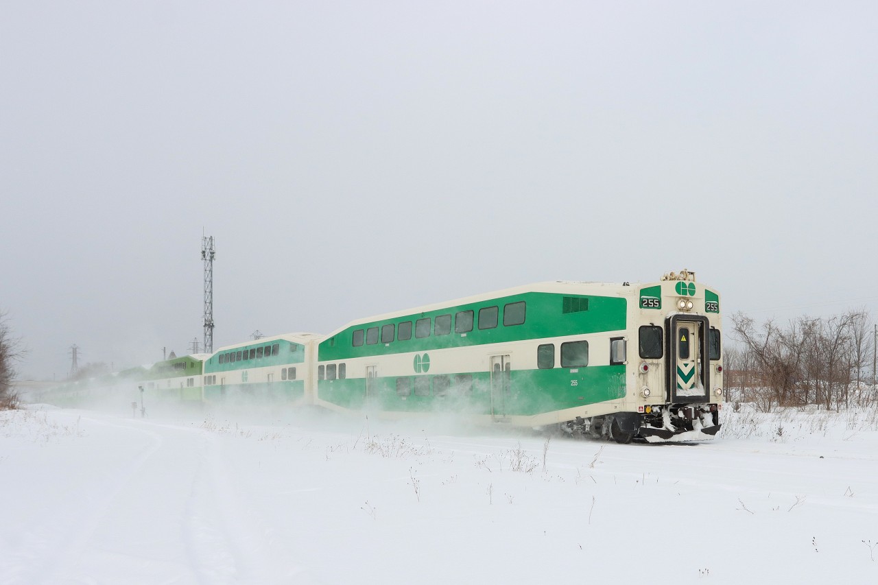 With an old style Cab Car GO 255 leading, the Niagara Falls bound GO Train kicks up the fresh fallen snow through Merritton.