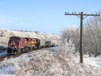 Lots of fog and hoar frost the past couple days in Calgary have coated everything. It looked really pretty. I went down from my house to see if I could capture it with a train. This westbound grain train is approaching Keith and it will take the siding, to allow an eastbound to pass on by.
