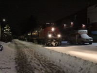 Just after midnight on January 17, 2026, CN 566 continues northbound along the Waterloo Spur about to cross Moore Ave. and Union St. Power was CN 4790-CN 4956. 