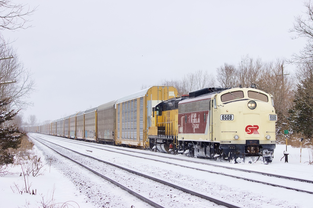 Living in the 1950’s in 2026. This pair sure have received a lot of attention lately, so myself and my boys were hoping luck would be in our side with a day off and a trip towards Woodstock. Thankfully FP9 6508 was out in the snow along with GP9 102. While all the attention goes to the veteran F unit the 102 deserves attention as well. EMD’s GP9 locomotive was one of the most successful models ever built and the 102 has the honour of being the very last one built when it was delivered to the Algoma Central Railway. I caught up with the pair after venturing through a cemetery in Ingesol. The power had just finished lifting 30+ auto racks from the CN interchange at Beachville and were heading back to home rails. Unfortunately up ahead switch and mechanical issues, thanks to the bitter cold slowed operations today, but the pair finally made Woodstock before darkness took over.