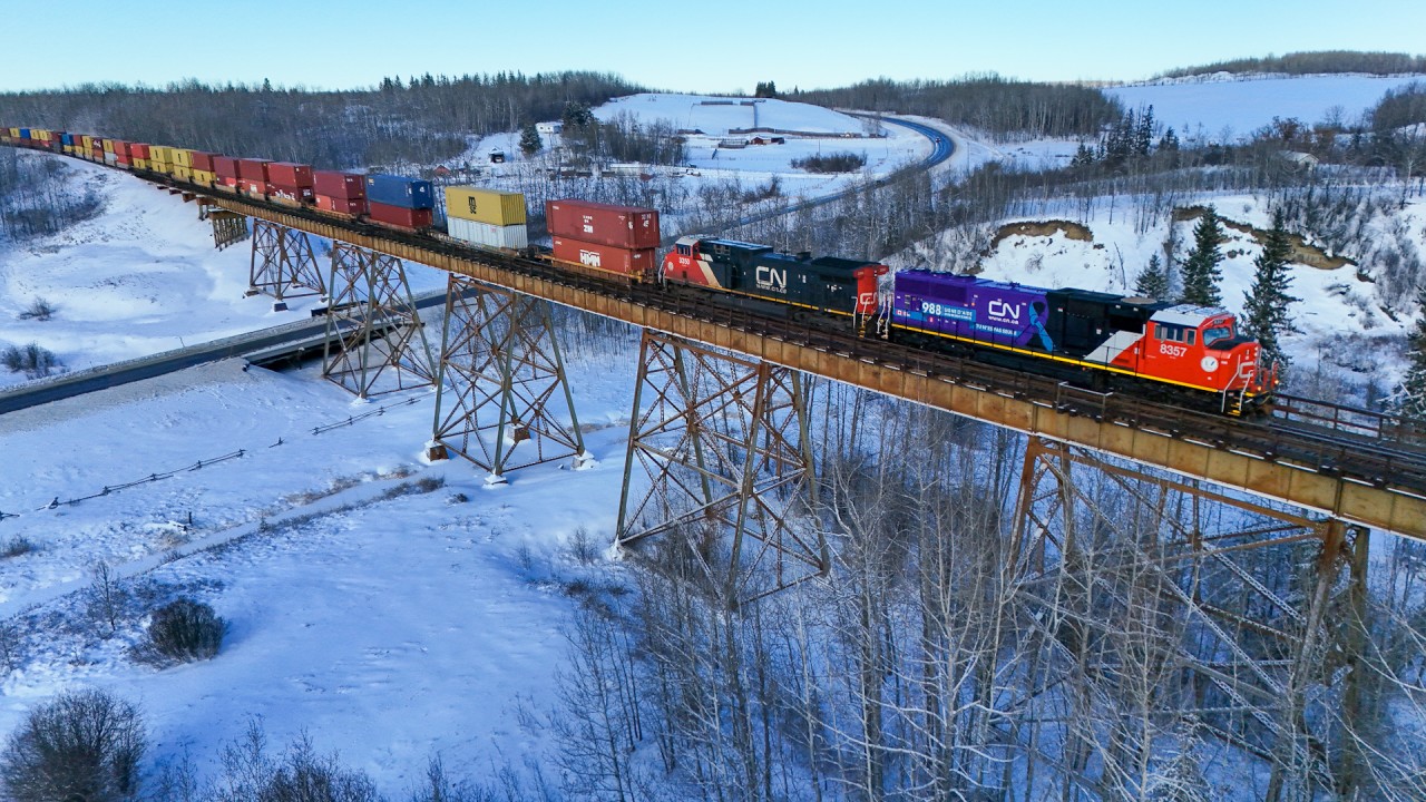 Q 10251 04 soars across the Sturgeon River with CN 8357 leading.