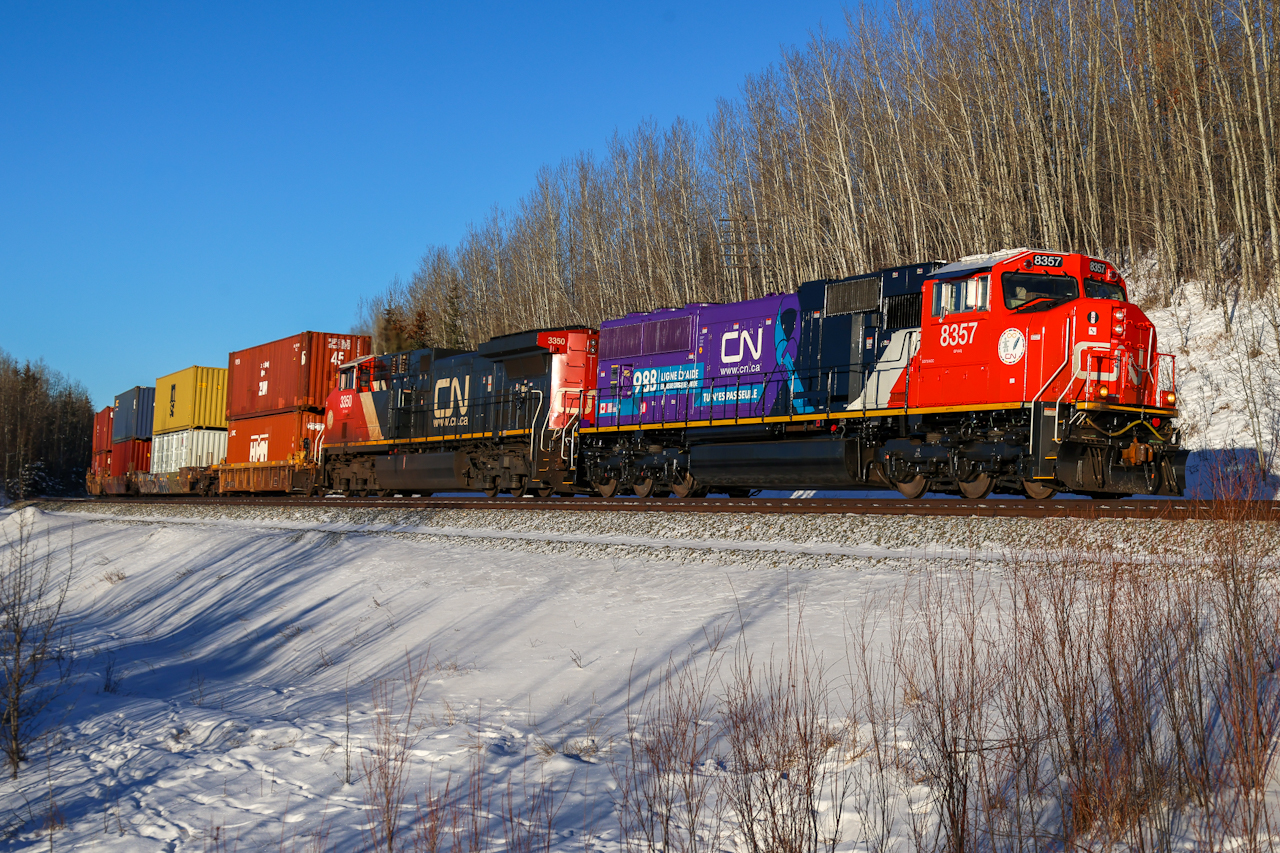 Q 10251 04 rolls through Big Eddy with brand new SD75IACC, on its first cross country trip in the lead.  The 8357, sports a special scheme to promote mental health awareness with a message of “You are not alone” and the 988 number for the Suicide and Crisis Lifeline