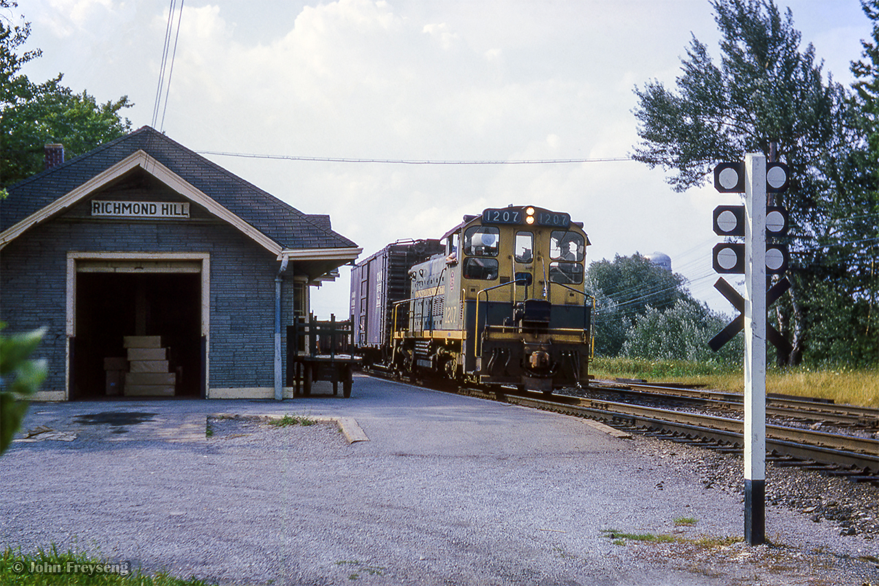 Southbound on the Bala Sub, a local freight passes the 1906-built station at Richmond Hill.  Closed in 1968, the structure was relocated to the Richmond Hill Soccer Club, where it is well preserved.

Scan and editing by Jacob Patterson.